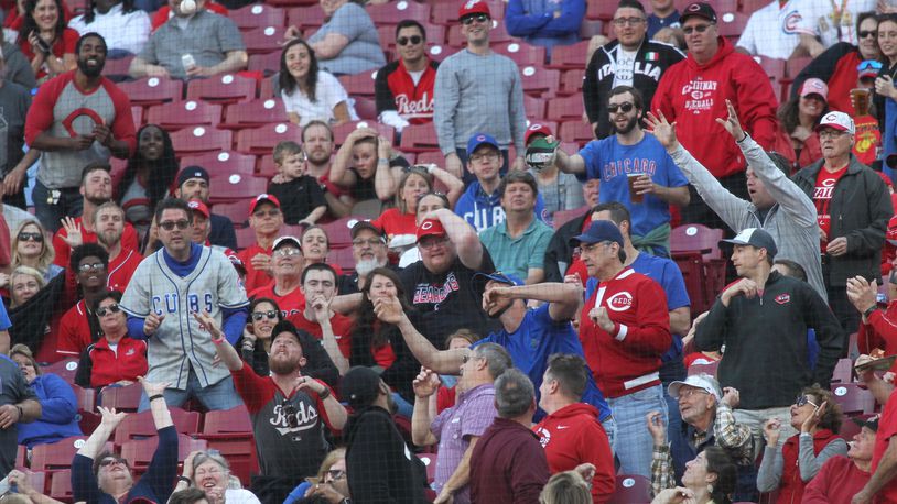 Fans try to catch a foul ball during a game between the Reds and the Cubs on Tuesday, May 14, 2019, at Great American Ball Park in Cincinnati.