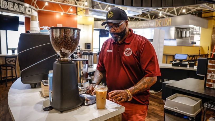 Bill Miller, owner of Miller’s Grind & Brew, makes a tall iced coffee. JIM NOELKER/STAFF