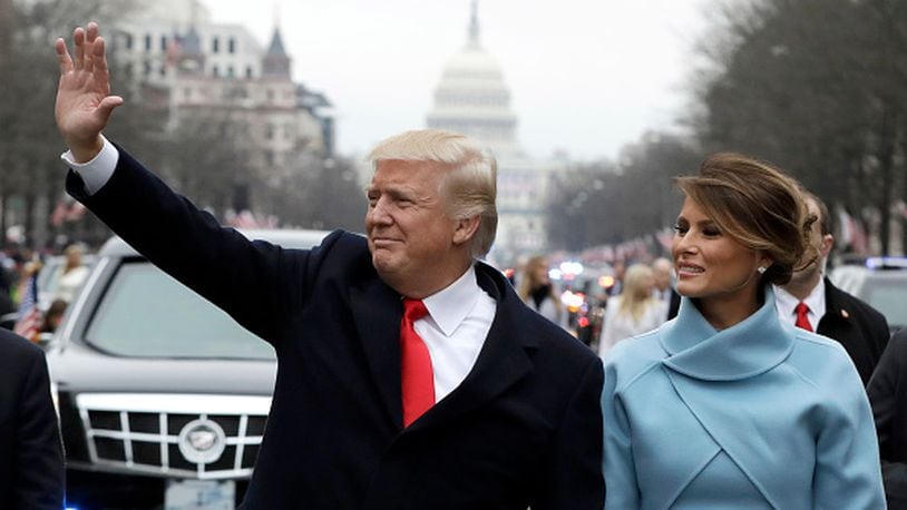 WASHINGTON, DC - JANUARY 20:  U.S. President Donald Trump waves to supporters as he walks the parade route with first lady Melania Trump after being sworn in at the 58th Presidential Inauguration January 20, 2017 in Washington, D.C. Donald J. Trump was sworn in today as the 45th president of the United States  (Photo by Evan Vucci - Pool/Getty Images)