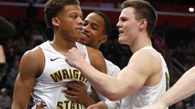 Wright State’s Everett Winchester, left, celebrates a basket with Jaylon Hall and Grant Benzinger during the second half of the team’s NCAA college basketball game against Cleveland State for the championship in the Horizon League men’s tournament in Detroit, Tuesday, March 6, 2018. (AP Photo/Paul Sancya)