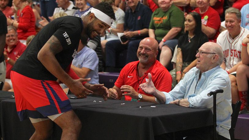 Devin Oliver, of the Red Scare, greets WHIO Radio’s Larry Hansgen and Bucky Bockhorn before the first-round game in The Basketball Tournament on Friday, July 19, 2019, at Capital University in Bexley. David Jablonski/Staff