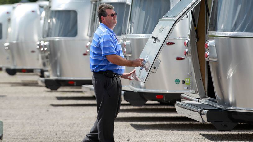 Marion Slater, Airstream Inc. director of manufacturing, opens a finished Airstream RV waiting to be shipped in Jackson Center in this 2014 photo. JIM WITMER / STAFF