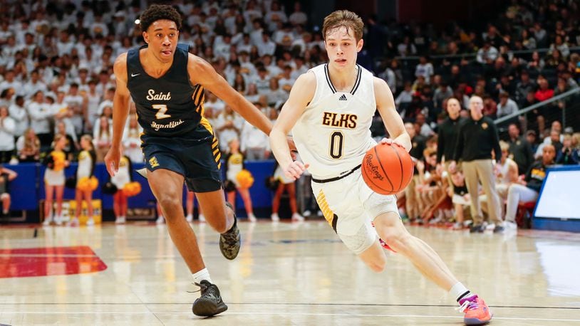 Centerville High School junior Gabe Cupps drives past Cleveland St. Ignatius' Carter Jackson during their game against Cleveland St. Ignatius on Saturday night at UD Arena. Michael Cooper/CONTRIBUTED
