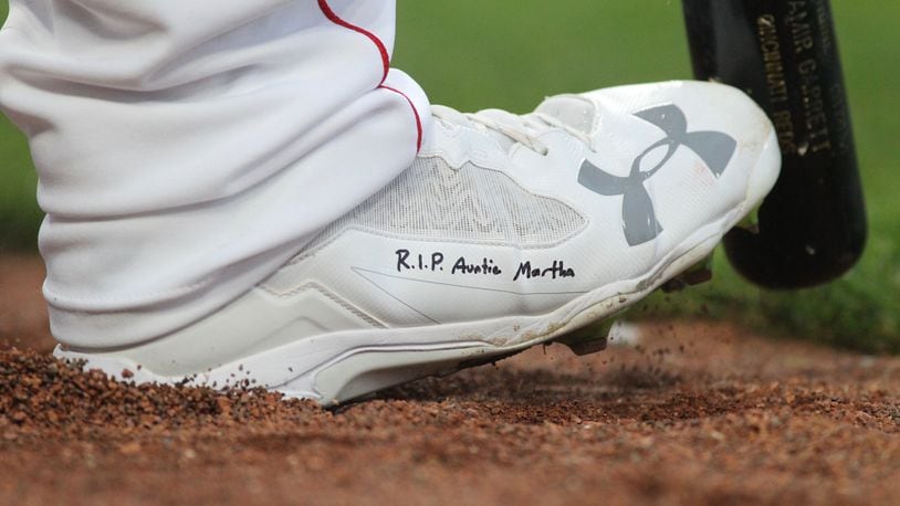 Reds starter Sal Romano wears a cleat with the words, “R.I.P. Auntie Martha” on Thursday, April 12, 2018, at Great American Ball Park in Cincinnati. David Jablonski/Staff