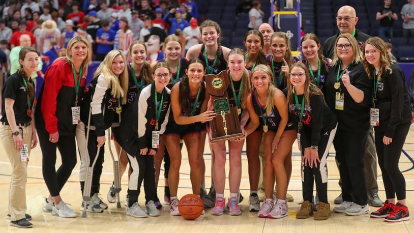 The top-ranked and undefeated Tri-Village High School girls basketball team poses with the trophy after beating Toledo Christian 52-50 on Saturday afternoon at UD Arena to win their first girls basketball state championship in school history. CONTRIBUTED PHOTO BY MICHAEL COOPER