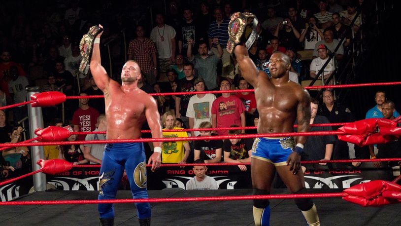 Shelton Benjamin (right) holds the Ring of Honor tag team titles alongside teammate Charlie Haas. Benjamin, now working for WWE, posted a tweet Wednesday after finding a loaded pistol in his rental car. Contributing photo