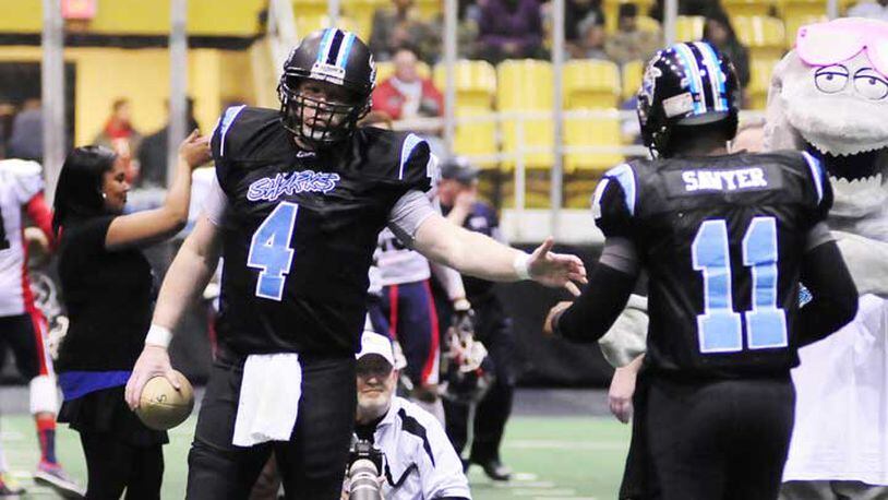 Dayton Sharks quarterback Tommy Jones (4) welcome Evan Sawyer (11) during opening ceremonies during the CIFL Dayton Sharks inaugural home game at Hara Arena against the Port Huron Patriots on Friday evening Feb. 15, 2013.