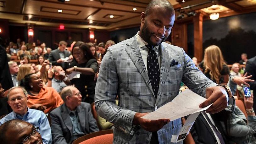 In this March 17, 2017, photo, Myron Rolle opens his "Match Day" letter that shows where he will continue his medical education and residency, in Tallahassee, Fla. Rolle was an All-American defensive back at Florida State but his bigger accomplishments have come off the field. He was a Rhodes Scholar and last month graduated from Florida State's College of Medicine. Rolle begins his neurosurgery residency next month at Harvard Medical School.  (Toni L. Sandys/The Washington Post via AP)