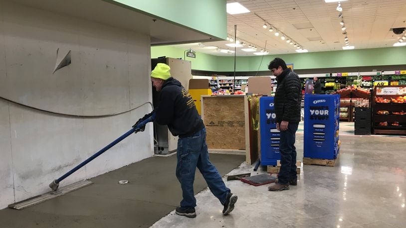Workers pave the base layer for what will be new tiled floor at the Xenia Kroger. Staff photo / Sarah Franks