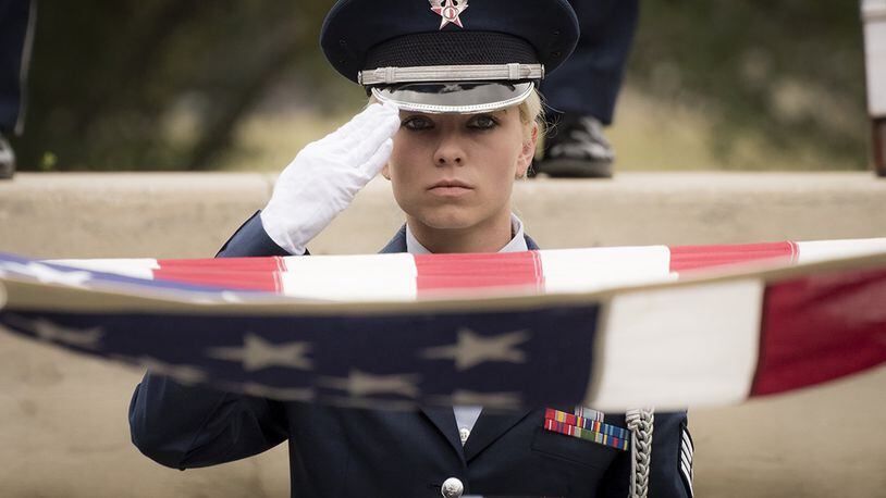 Staff Sgt. Elena Konter, 96th Medical Operations Squadron, salutes during the flag-folding portion of the unit’s graduation ceremony at Eglin Air Force Base, Fla., March 1. Approximately 12 new Airmen graduated from the 120-plus-hour course. The graduation performance includes flag detail, rifle volley, pall bearers and bugler for friends, family and unit commanders. (U.S. Air Force photo/Samuel King Jr.)