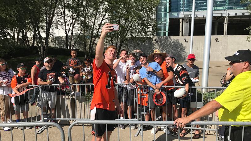 Cincinnati Bengals quarterback Andy Dalton takes a selfie with a fan’s phone after practice Friday. JAY MORRISON/STAFF