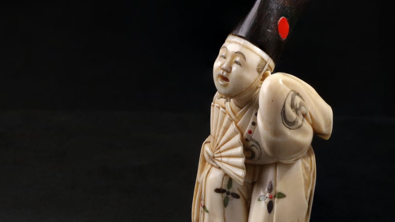 Netsuke in the Shape of a Sambaso Dancer, late 19th–early 20th century, ivory, wood, inlay. CONTRIBUTED