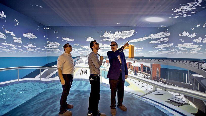 Wearing 3D glasses, Richard Fain, Chairman and CEO of Royal Caribbean Cruises Limited, right, chats with architects Paul Moreira, left, and Tom Wright, of WKK Architects, inside the 3D cave which is part of the new ship technology Royal Caribbean. (Patrick Farrell/Miami Herald/TNS)