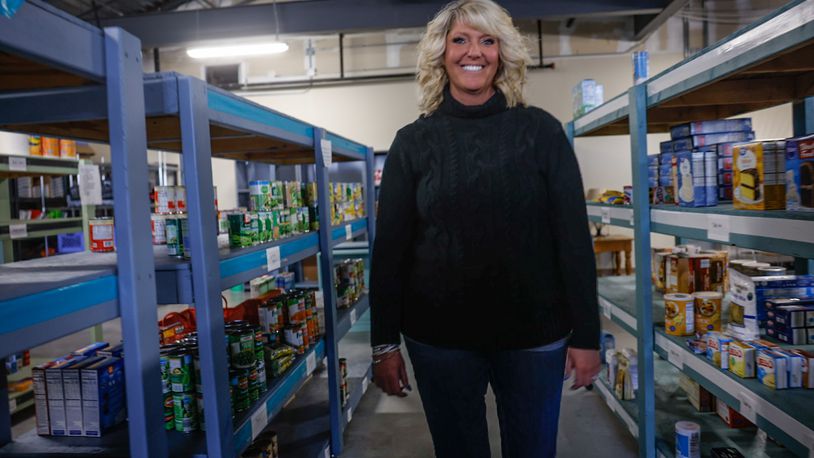 Springboro Community Assistance Center Director, Wendy Grothjan stands in the schools' large food pantry for students and families. JIM NOELKER/STAFF