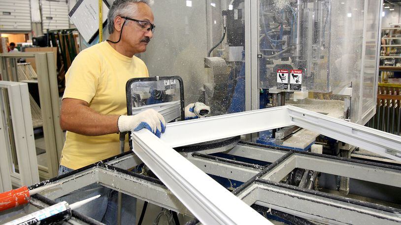 An employee assembles vinyl windows at Vinylmax in Hamilton. The company’s “aggressive growth strategy” finds it looking for 30 new employees over the next 18 months, according to Craig Doerger, owner and vice president of operations. STAFF FILE PHOTO