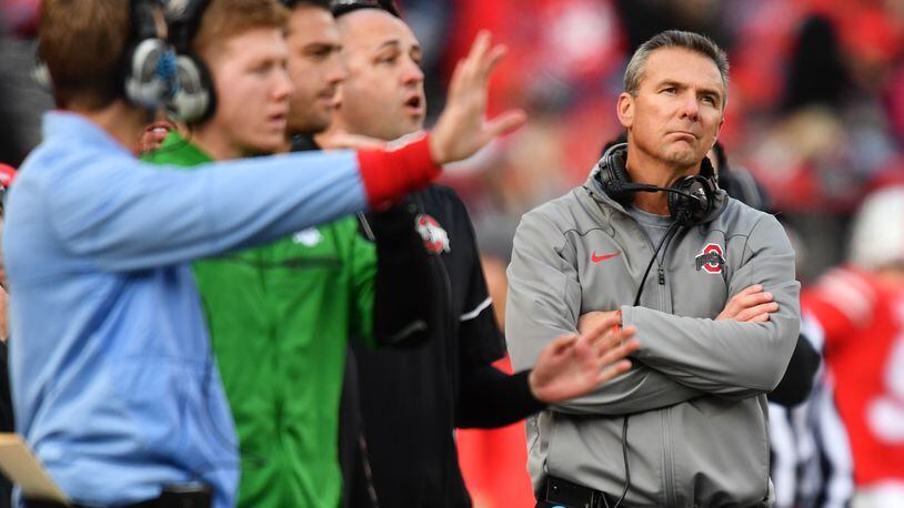 COLUMBUS, OH - NOVEMBER 11:  Head Coach Urban Meyer of the Ohio State Buckeyes looks up at the scoreboard as his coaches send in plays in the fourth quarter against the Michigan State Spartans at Ohio Stadium on November 11, 2017 in Columbus, Ohio. Ohio State defeated Michigan State 48-3.  (Photo by Jamie Sabau/Getty Images)