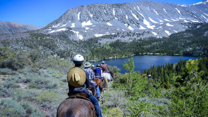 Guests and packers from Rock Creek Pack Station start their ride back to the station from Davis Lake. (Christopher Reynolds/Los Angeles Times/TNS)