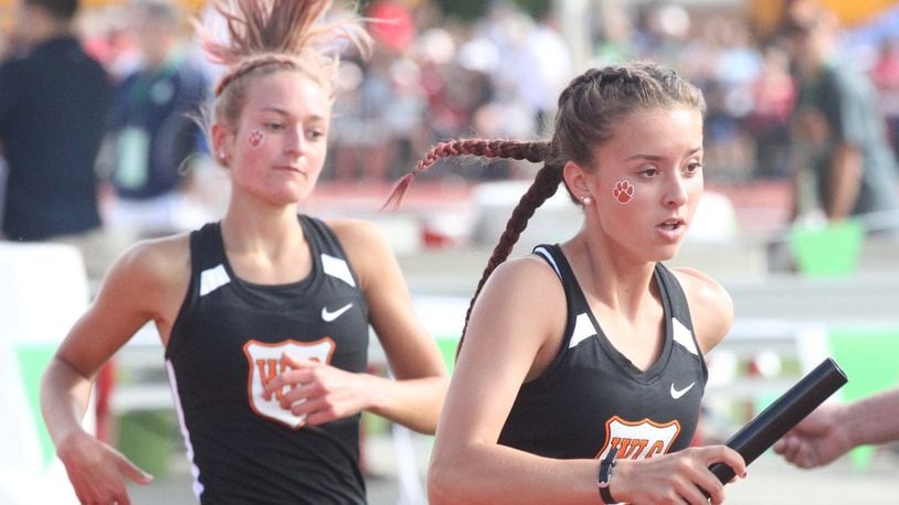 West Liberty-Salem’s Katelyn Stapleton, right, takes the baton from Madison Bahan for the final leg of the 4x800 relay at the Division III state track and field championships on Friday, May 31, 2019, at Jesse Owens Memorial Stadium in Columbus. David Jablonski/Staff