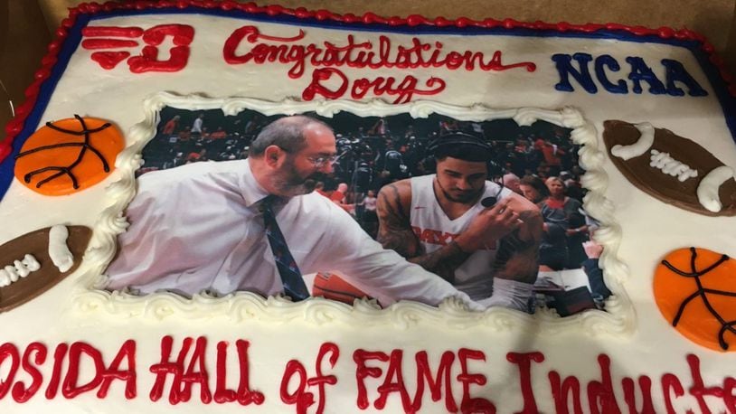 A cake celebrating the news of Doug Hauschild going into the COSIDA Hall of Fame is pictured at UD Arena on Feb. 28, 2020. David Jablonski/Staff