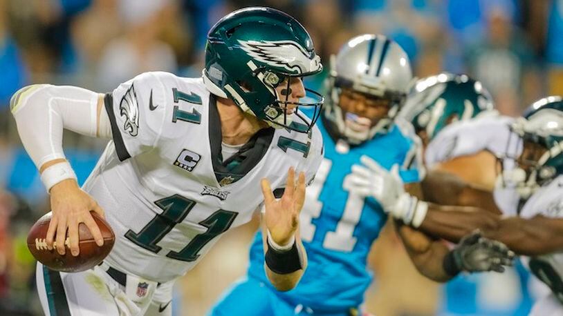 Philadelphia Eagles' Carson Wentz (11) scrambles out of the pocket against the Carolina Panthers during the first half of an NFL football game in Charlotte, N.C., Thursday, Oct. 12, 2017. The Eagles won 28-23. (AP Photo/Bob Leverone)