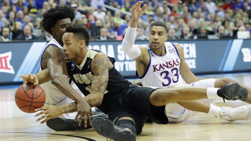 KANSAS CITY, MO - MARCH 23: Josh Jackson #11 of the Kansas Jayhawks and Vince Edwards #12 of the Purdue Boilermakers battle for a loose ball in the second half during the 2017 NCAA Men’s Basketball Tournament Midwest Regional at Sprint Center on March 23, 2017 in Kansas City, Missouri. (Photo by Ronald Martinez/Getty Images)