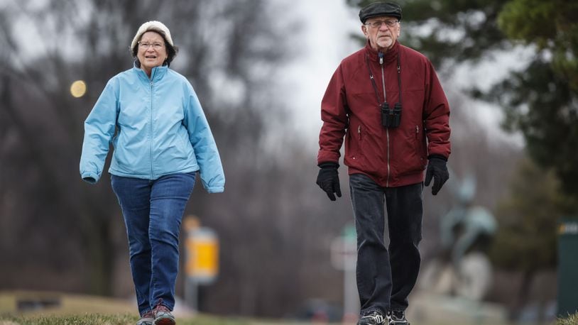 Marilyn Calondis and Joe Niebel, from West Carrollton, walk along the Great Miami River near Carillon Park for exercise and to keep an eye on the eagles that nest in the park. JIM NOELKER/STAFF