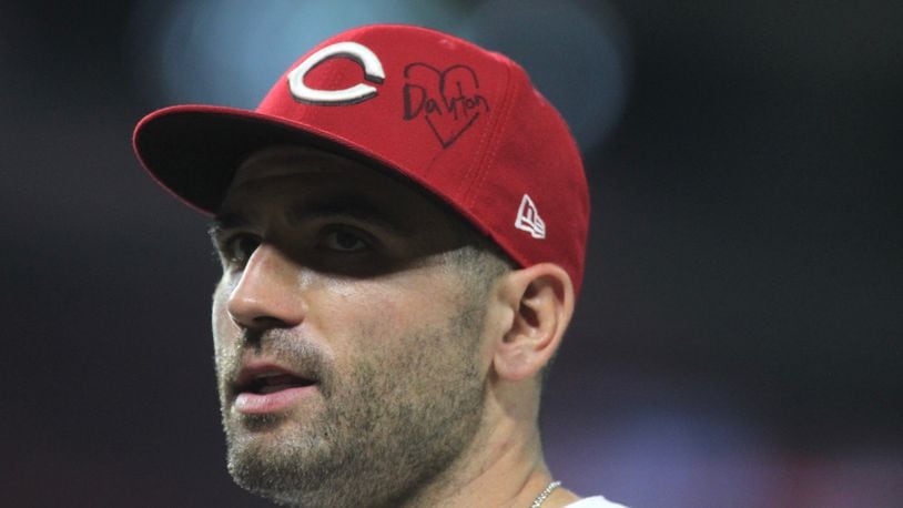 Reds first baseman Joey Votto wears a hat paying tribute to Dayton during a game against the Angels on Tuesday, Aug. 6, 2019, at Great American Ball Park in Cincinnati.