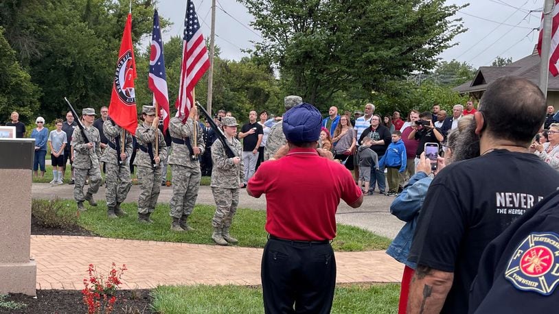 Military service members carried flags before the national anthem was played as more than 100 people who attended the 9/11 memorial event Sunday in Beavercreek. NICK BLIZZARD/STAFF