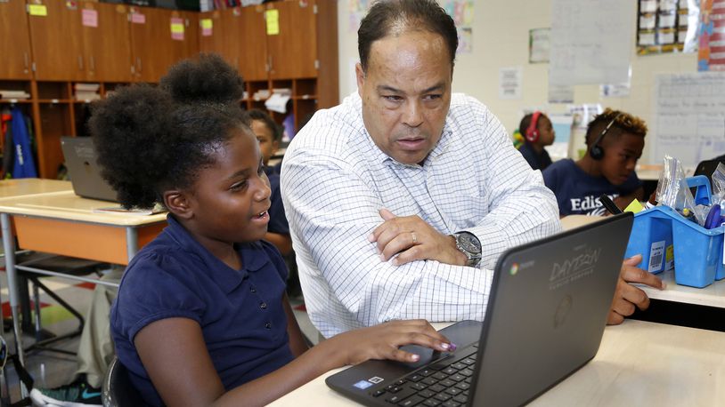 Anthony Taylor, a third-grade teacher at Edison PreK-6 in Dayton, works with A-Robbin Crisp in class last year. LISA POWELL / STAFF