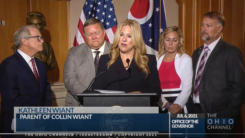 Kathleen Wiant speaks about her son Collin, a college student who died as a result of hazing, during a news conference Tuesday before Ohio Gov. Mike DeWine, left, signed an anti-hazing law. Also pictured are Collin's father Wade Wiant and at right, Shari and Cory Foltz, the parents of Stone Foltz, who also died in a hazing incident. THE OHIO CHANNEL