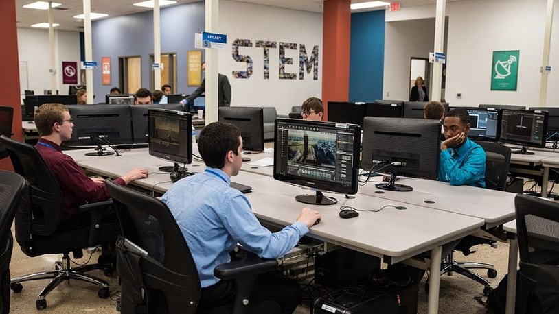 Air Force Research Laboratory Legacy interns work on their projects in the new Gaming Research Integration and Learning Laboratory space prior to the ribbon-cutting ceremony June 7 at the Dayton Regional STEM School. (U.S. Air Force photo/Richard Eldridge)