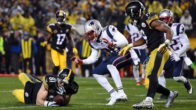 PITTSBURGH, PA - DECEMBER 17: Jesse James #81 of the Pittsburgh Steelers dives for the end zone for an apparent touchdown in the fourth quarter during the game against the New England Patriots at Heinz Field on December 17, 2017 in Pittsburgh, Pennsylvania. After official review, it was ruled an incomplete pass (Photo by Joe Sargent/Getty Images)