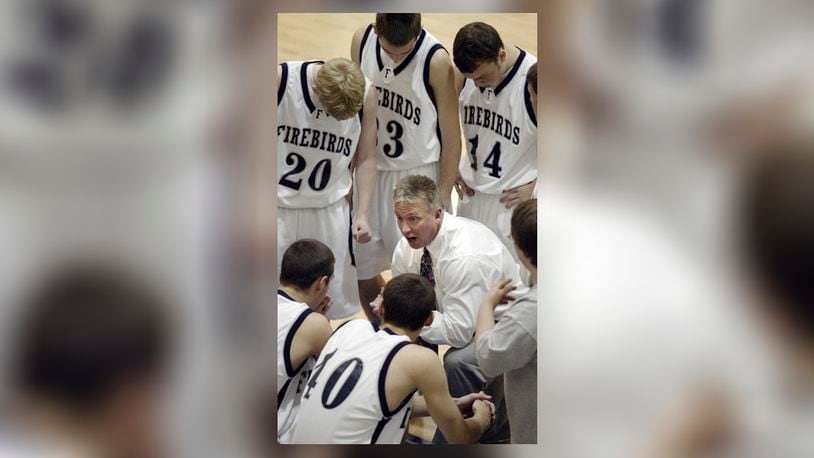 Fairmont basketball coach Hank Bias gives his team a pep talk before taking the floor.  Bias is one of five being inducted into the Fairmont Hall of Fame this weekend. DDN FILE PHOTO