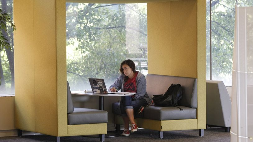 Gloria Campos, 19, utilizes new furniture in the Paul Laurence Dunbar Library at Wright State University to study physics. The library recently completed a renovation that included new furniture and carpet to replace the 30-year-old furnishings which were recycled throughout the university. TY GREENLEES / STAFF