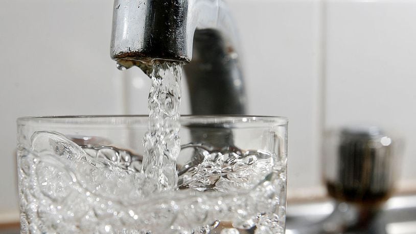 A glass of water is filled at a kitchen tap. (File Photo by Cate Gillon/Getty Images)
