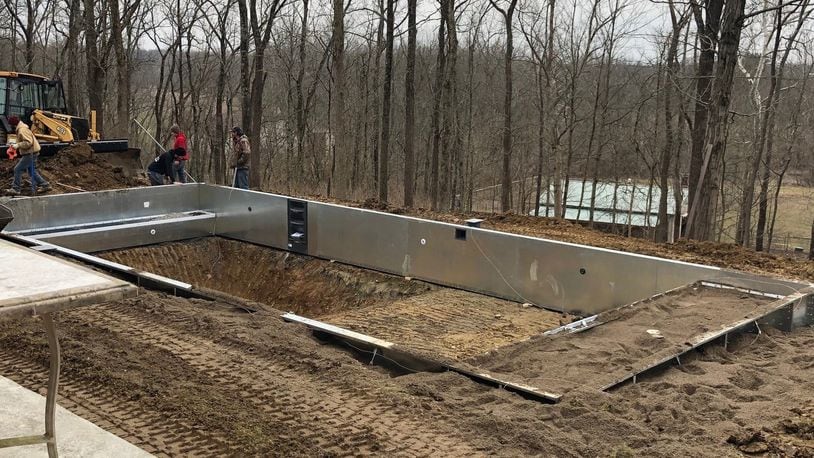 Employees with Heatwave Pools in Cincinnati work to build an inground pool in January. The company’s owner said this is the first January in the history of his company where they have been able to work on a pool project. STAFF