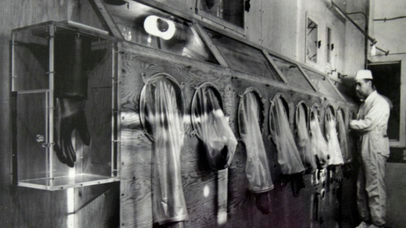 The Mound Museum in Miamisburg houses technology, worker information and photographs of its' history including this photograph taken in 1946 of a worker on the first glove box line processing polonium.  Photo from the Mound Museum archive