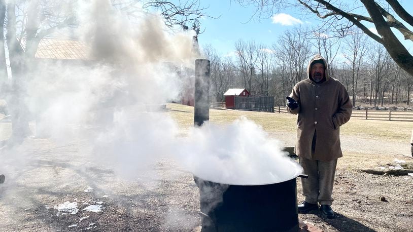 Rick Musselman, outdoor education director at Five Rivers MetroParks, stands next to a boiling pot of maple sap during Saturday's maple sugaring event at Carriage Hill MetroPark.