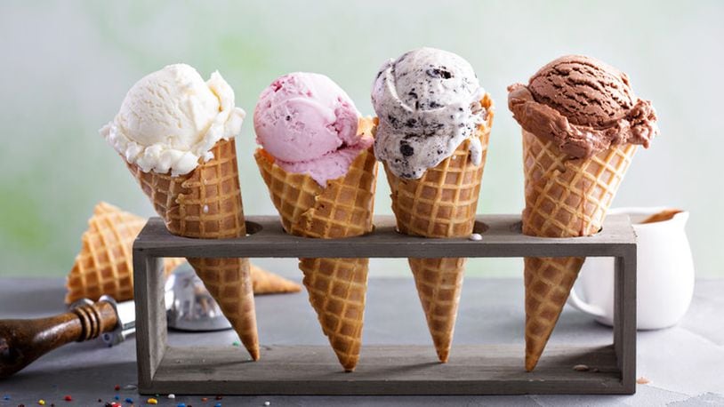Variety of ice cream scoops in cones with chocolate, vanilla and strawberry. Getty Image