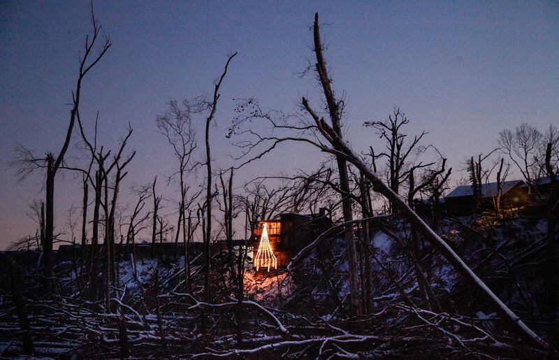 In December 2019, Allison Sandivar's holiday exhibit lit up the tree-strewn, tornado-ravaged Stillwater River bank below her home in Harrison Twp.  CHRIS STEWART / STAFF