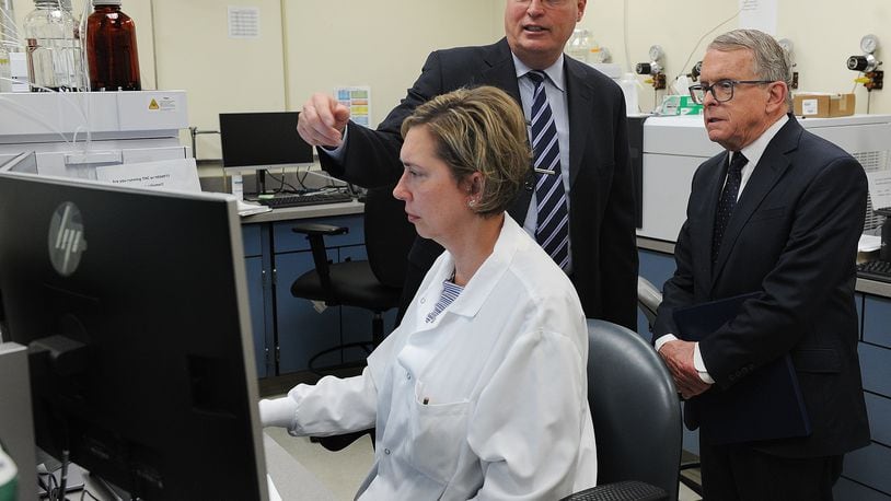 Montgomery County Coroner Dr. Kent Harshbarger, left, shows  Ohio Governor Mike DeWine around the Miami Valley Regional Crime Lab, Monday May 9, 2022. The Governor visited the lab to discuss the new Ohio Crime Lab efficiency program that was developed to help eliminate-processing backlogs and increase the speed at which criminal evidence is analyzed in certified crime laboratories across the state. MARSHALL GORBY\STAFF