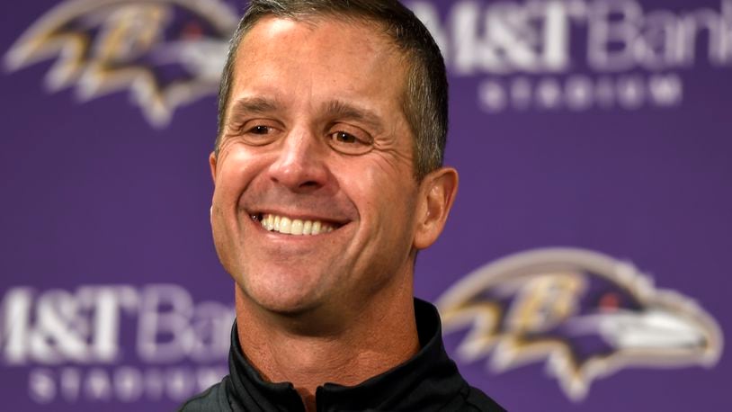 FILE - In this Sunday, Nov. 27, 2016, file photo, Baltimore Ravens head coach John Harbaugh answers a question during a post game press conference after defeating the Cincinnati Bengals 19-14, in Baltimore. With Baltimore leading Cincinnati by seven points, coach Harbaugh told his team to intentionally hold the Bengals to draw penalties while punter Sam Koch ran out of the back of the end zone. The strange but smart strategy ensured a victory for the Ravens rather than risking a fluke fumble or blocked kick. (AP Photo/Gail Burton, File)