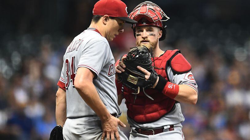 MILWAUKEE, WI - AUGUST 20:  Tucker Barnhart #16 of the Cincinnati Reds speaks with Homer Bailey #34 during the sixth inning of a game against the Milwaukee Brewers at Miller Park on August 20, 2018 in Milwaukee, Wisconsin.  (Photo by Stacy Revere/Getty Images)