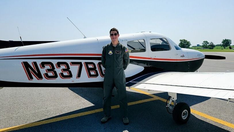 Aaron Staiger, an Air Force Junior ROTC cadet at Beavercreek High School, poses in front of a Piper PA-28-181 single-engine aircraft on July 26 after successfully completing his checkride for a private pilot’s license. CONTRIBUTED PHOTO