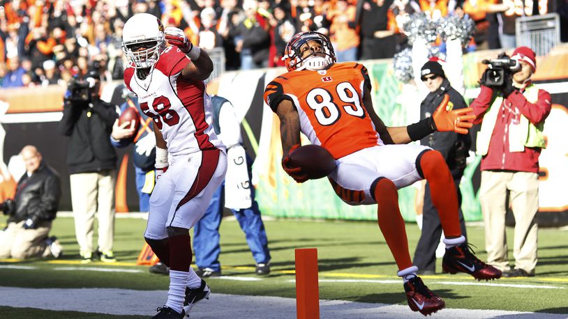 CINCINNATI, OH - DECEMBER 24: Jerome Simpson #89 of the Cincinnati Bengals jumps over Daryl Washington #58 of the Arizona Cardinals for a 19-yard touchdown during first half action at Paul Brown Stadium on December 24, 2011 in Cincinnati, Ohio. (Photo by Joe Robbins/Getty Images)