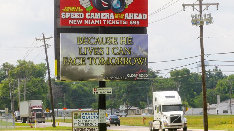 A billboard warned motorists of the speed cameras set up in New Miami, Thursday, June 27, 2013. GREG LYNCH / STAFF