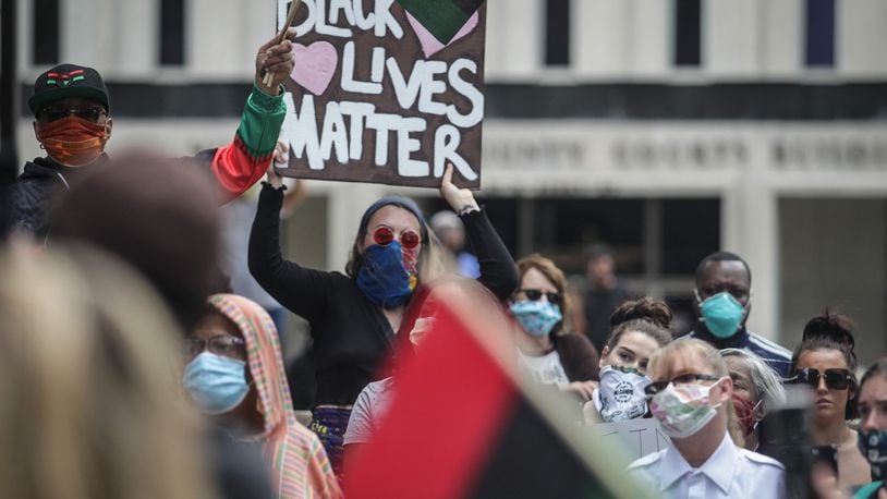 A large group of protesters, some with and some without masks, protested near the Federal Building in downtown Dayton last weekend. Large groups of people crowd together in closed quarters during these protest. JIM NOELKER/STAFF