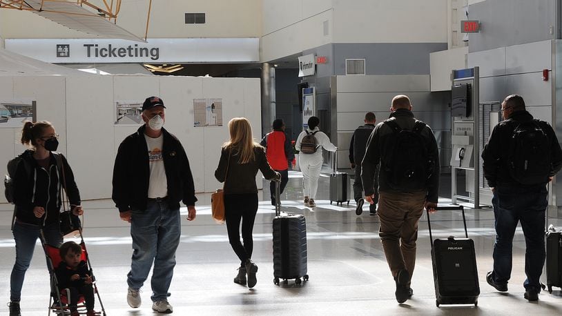 Travelers were making their way through the Dayton International Airport Thursday, Oct. 20, 2022. Prices at area airports have risen over the last year, according to federal data, and experts say that people who plan to travel during the upcoming holidays should buy their tickets as soon as possible. MARSHALL GORBY\STAFF