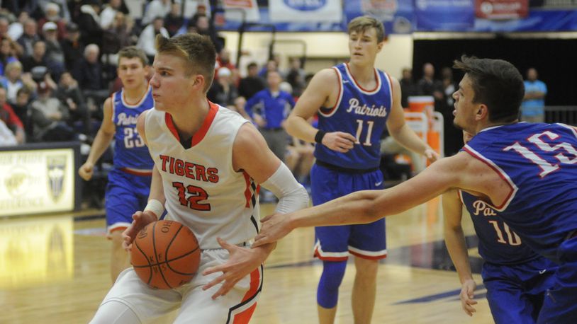 Versailles’ Justin Ahrens (with ball) had 26 points and Trace Couch (15) 24 to lead Tri-Village. MARC PENDLETON / STAFF