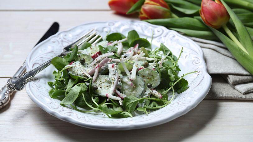 Creme fraiche mixes with fresh chives and dill and lemon juice and zest for a rich dressing to contrast with crisp cucumbers and radishes. (E. Jason Wambsgans/Chicago Tribune/TNS)